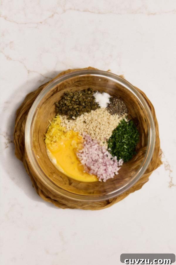 Lemon Caper Chicken Meatballs 6 Shallots, capers, parsley, egg, lemon zest, and panko in a bowl for chicken piccata meatballs.