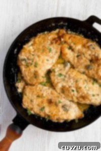A skillet filled with classic chicken piccata