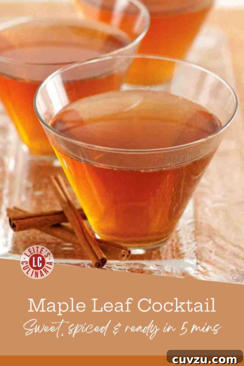 Autumn Ember 3 Three bourbon maple leaf cocktails served in coupe glasses with cinnamon stick garnishes on a dark, rustic wooden surface, perfect for a cozy autumn evening.