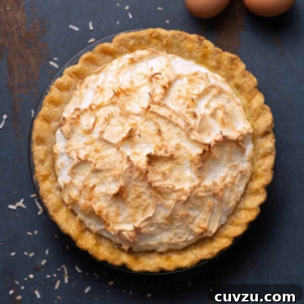 Tropical Coconut Dream Pie 12 A coconut cream pie with a meringue top and sprinkled with toasted shredded coconut.
