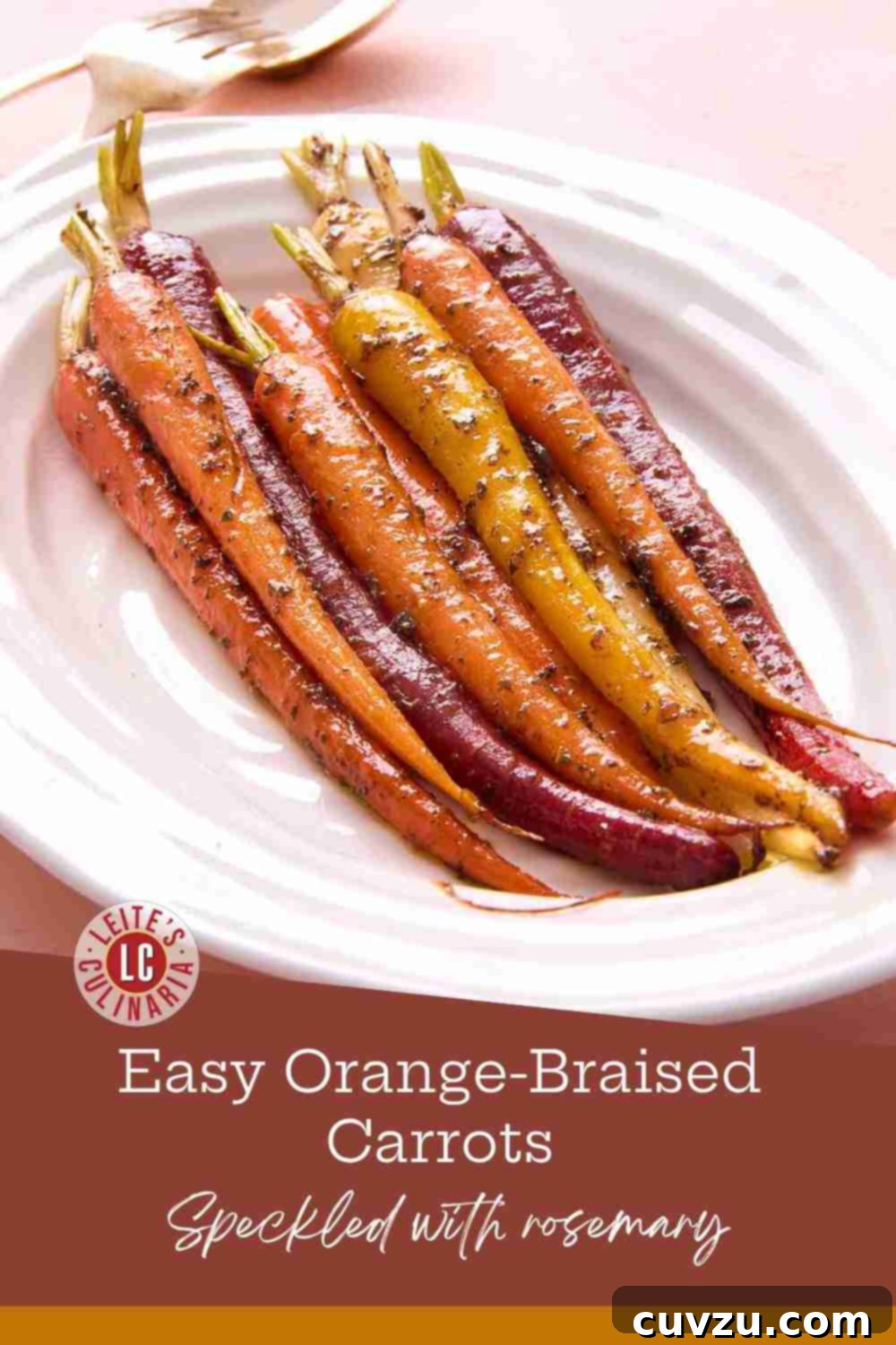 Slow-Simmered Orange Rosemary Carrots 3 Slender, multi-colored braised carrots, beautifully glazed and garnished with fresh rosemary, presented on a white serving platter.