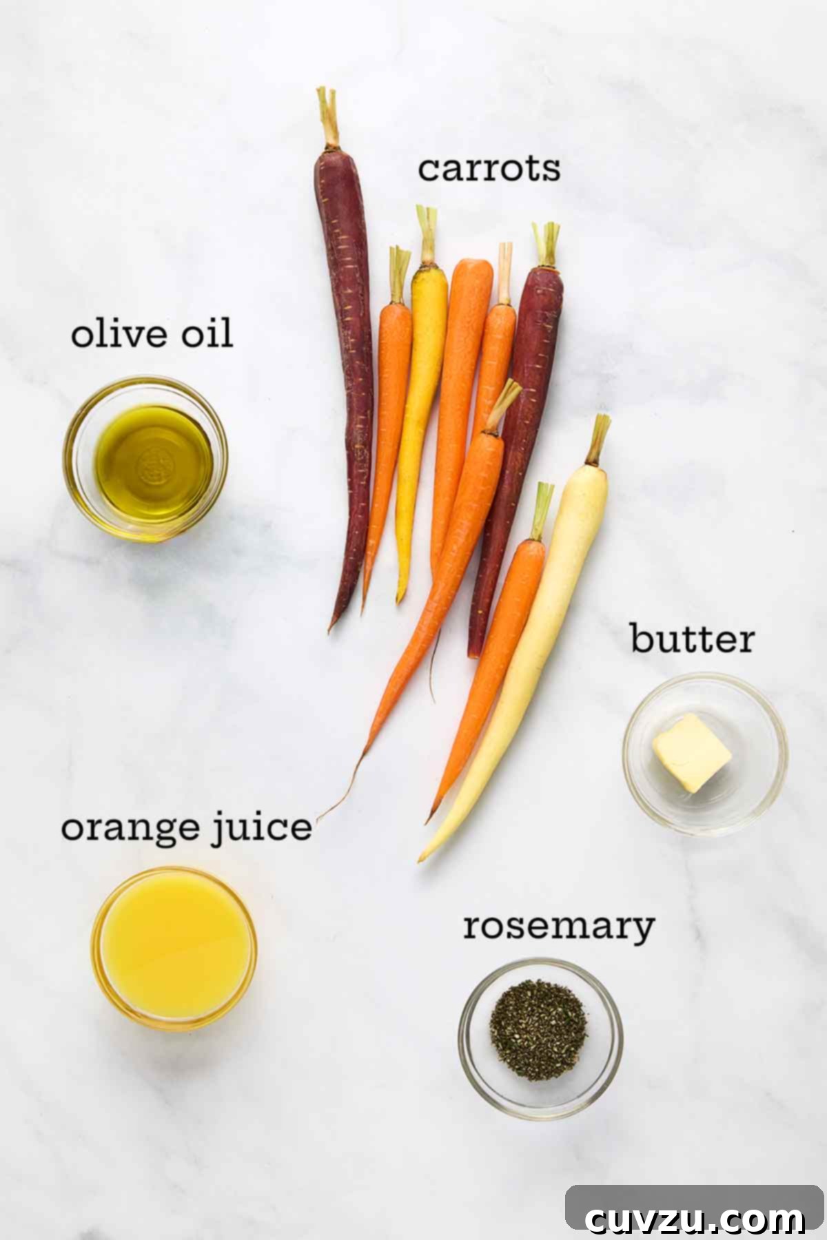 Slow-Simmered Orange Rosemary Carrots 5 Fresh carrots, olive oil, butter, fresh orange juice, and fragrant rosemary sprigs arranged as ingredients for braised carrots.