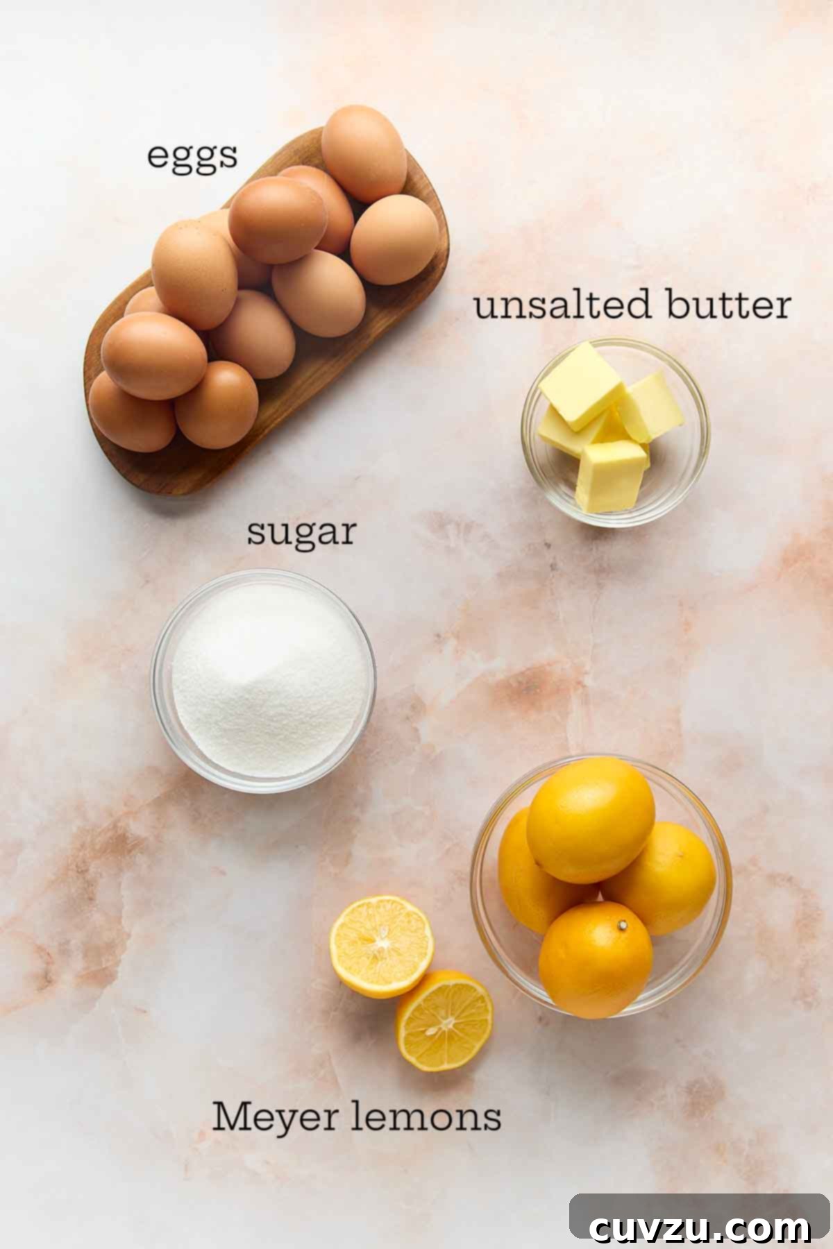 Meyer Lemon Curd: Zesty Citrus Delight 4 The ingredients for Meyer lemon curd: eggs, butter, sugar, and Meyer lemons laid out on a clean surface.