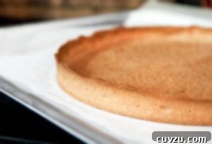 Pàte Sucrée |Tart Dough sits empty on a parchment lined baking sheet