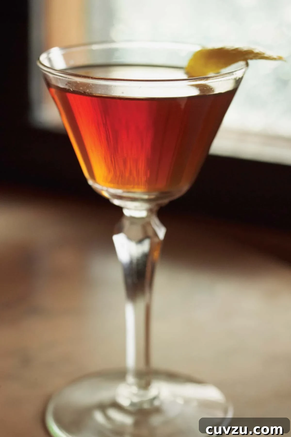 The Quintessential Manhattan 2 A classic, OG Manhattan cocktail in a stemmed glass with a twist of lemon.