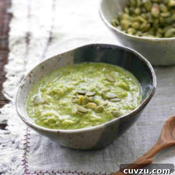 Pepita Green Mole 4 Pumpkin seed mole verde in a bowl, garnished with pumpkin seeds.