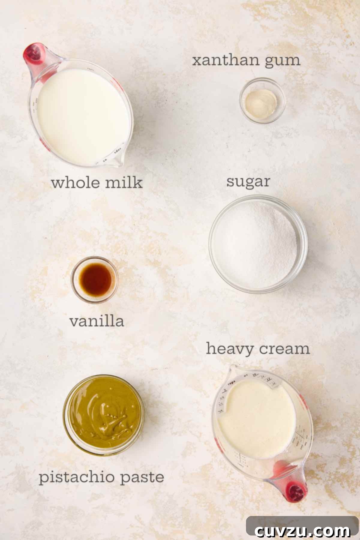 Authentic Italian Creamy Pistachio Gelato 5 A display of fresh, high-quality ingredients for making pistachio gelato, including milk, cream, pistachio paste, sugar, xanthan gum, and vanilla extract.