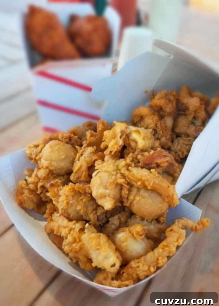 Crispy Coastal Clams 3 A paper basket filled with golden fried clams