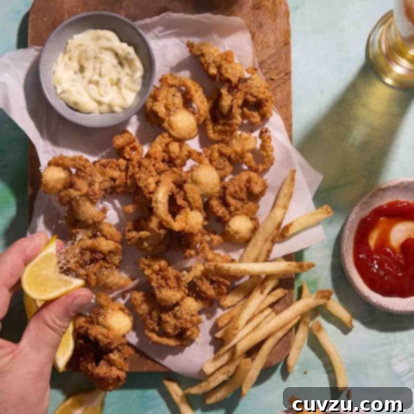 Crispy Coastal Clams 4 A square overhead shot of crispy fried whole belly clams, French fries, lemon, and dipping sauces.