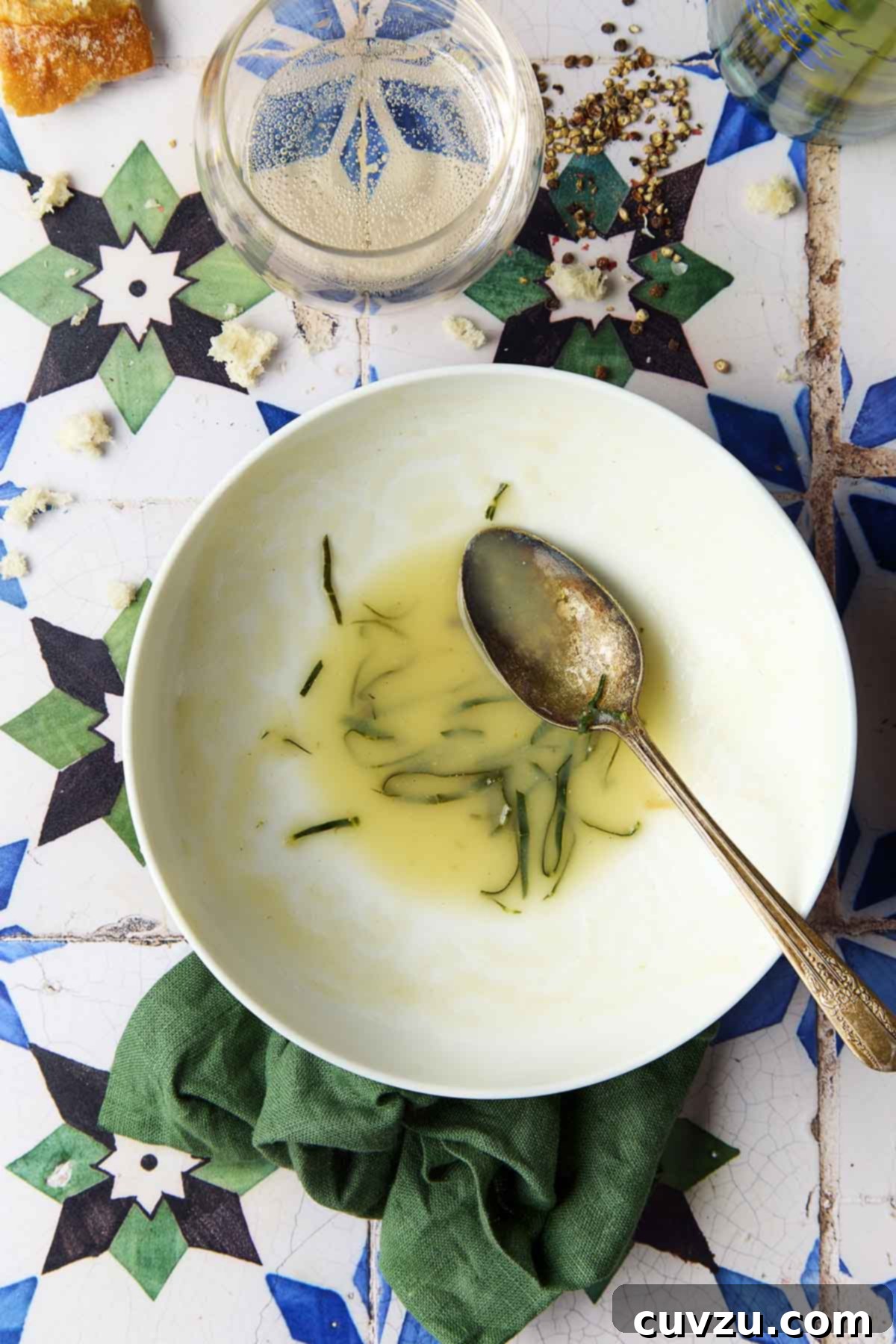 Caldo Verde: Portugal's Iconic Green Soup 12 An empty white bowl of caldo verde, or Portuguese kale soup (green broth), showing the last remnants of the creamy soup.