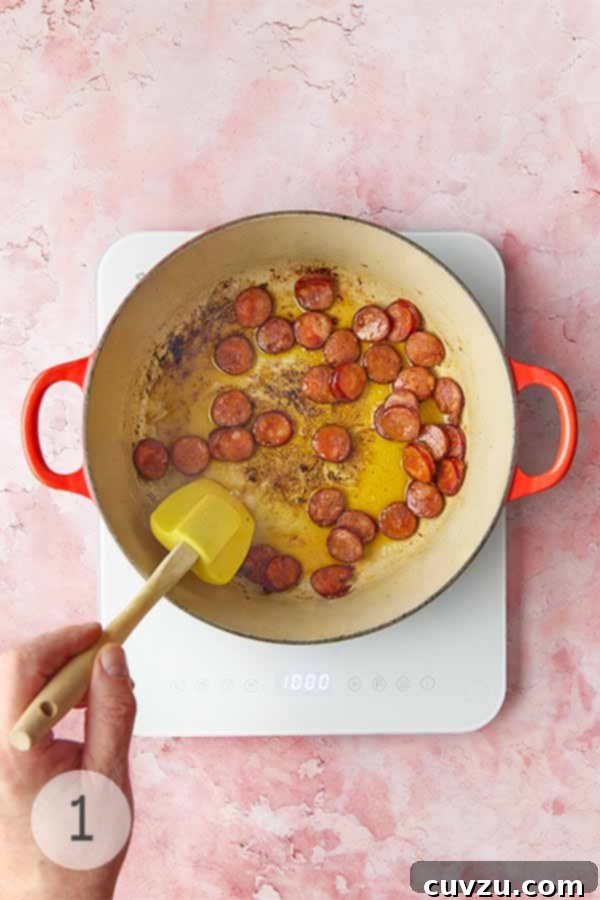 Caldo Verde: Portugal's Iconic Green Soup 6 Slices of Portuguese chouriço sausage being stirred and browned in a pot with olive oil.