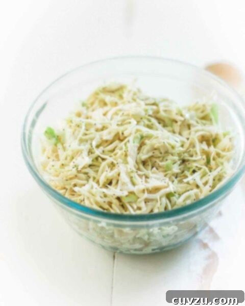 A glass bowl filled with creamy coleslaw.