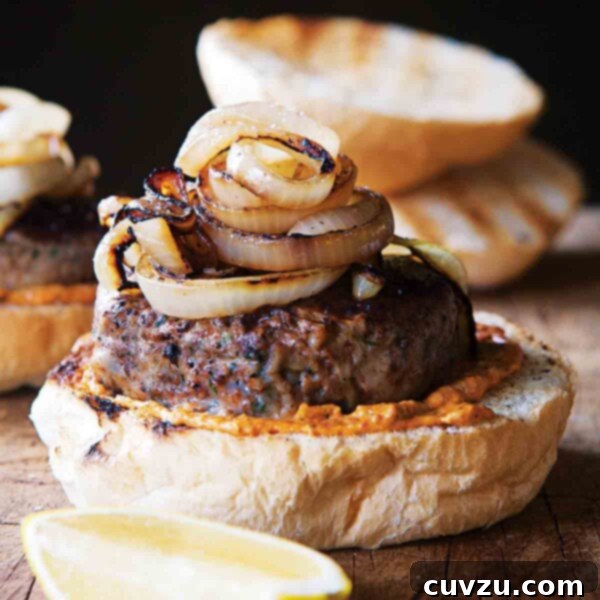 A delicious Greek Lamb Burger (Bifteki Arniou) on a bun with grilled onions.