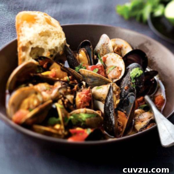 Hearty Portuguese Fish Pot 4 A rustic earthenware bowl holding a savory fish and shellfish stew, garnished with fresh herbs, ready to be enjoyed.