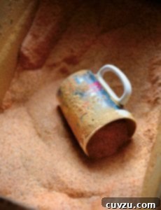 A smaller image of the Cajun spice mix in a mug, a closer look at the rich texture and color.