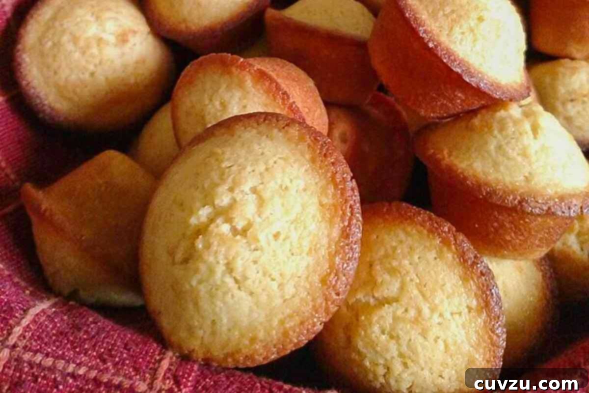 Portuguese mini lemon-orange cakes piled on top of each other in a red cloth.