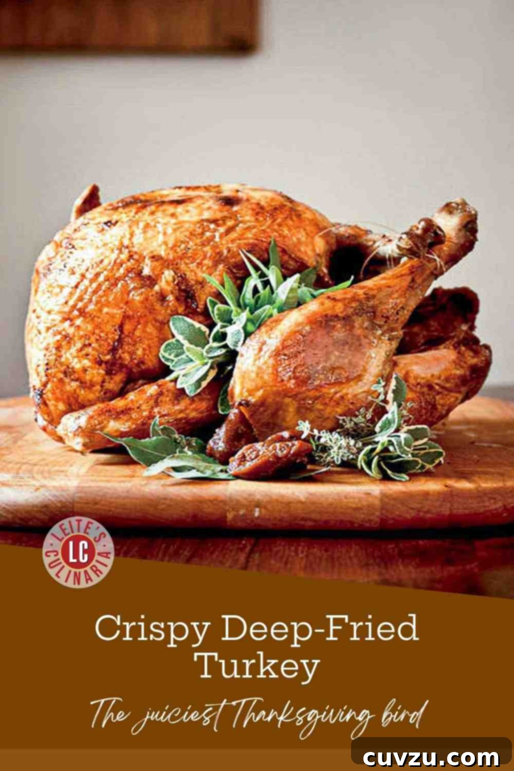 Crispy Golden Fried Turkey 3 Whole, deep-fried Cajun turkey with burnished, crisp skin resting on a wooden cutting board, garnished with fresh sage and thyme.
