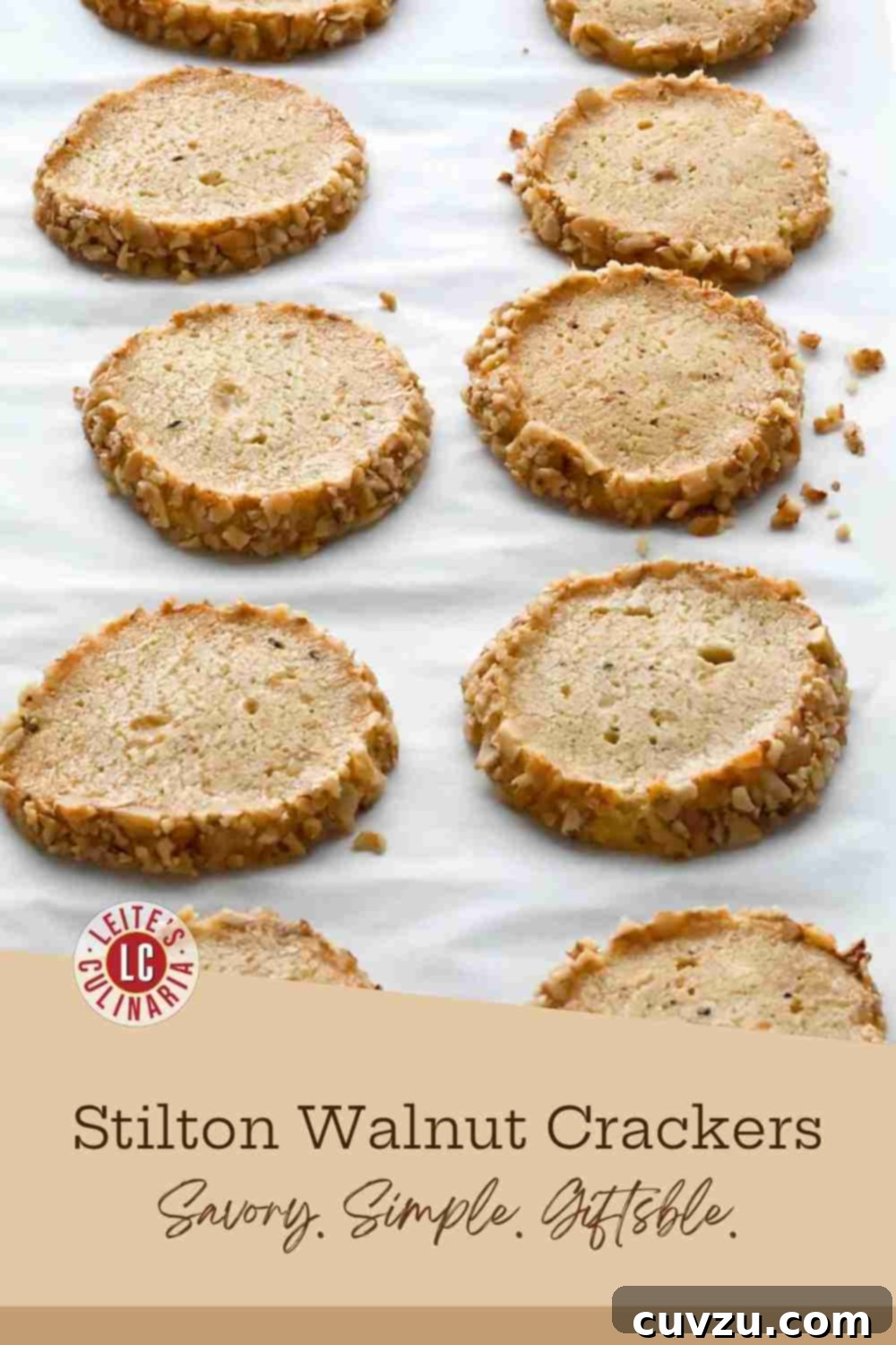 Tangy Stilton Walnut Bites 3 Ten baked Stilton and walnut shortbreads cooling on a parchment-lined baking sheet.