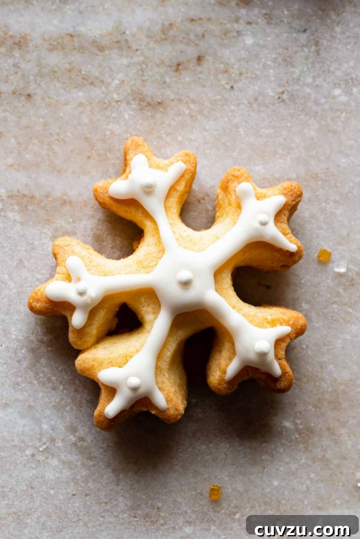 Sweet Christmas Tree Sculpture 2 A snowflake cookies frosted with royal icing on a granite background