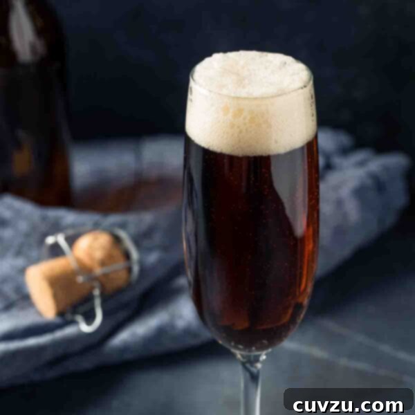 A black velvet cocktail in a flute, showcasing the distinctive layers of stout and champagne.