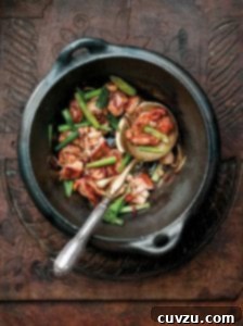 Black pottery bowl filled with the Chinese dish gung bao chicken
