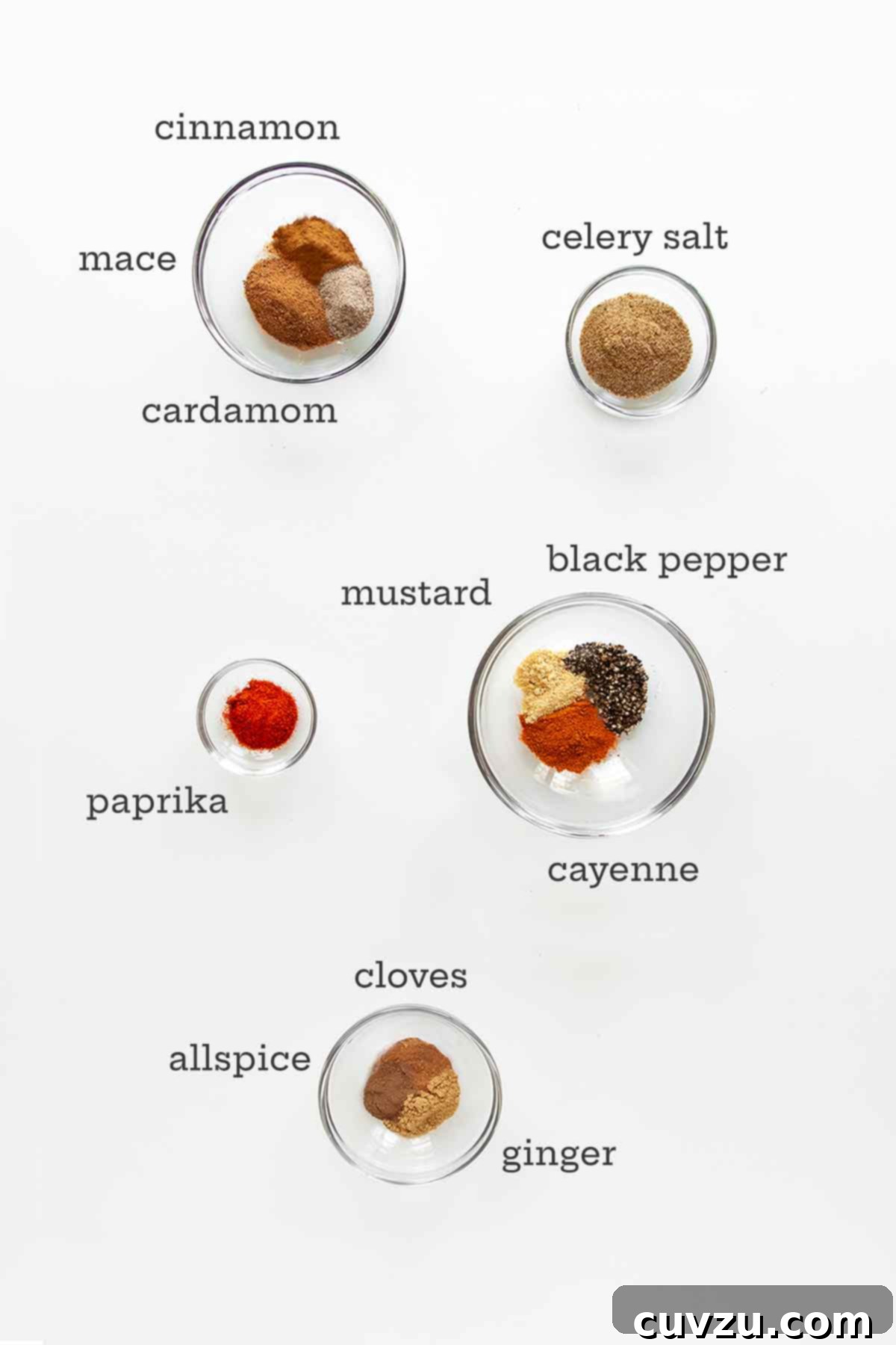 Craft Your Own Old Bay Seasoning 4 Five small glass bowls containing individual spices like celery salt, paprika, black pepper, and ground mace, meticulously laid out before being mixed to create homemade Old Bay seasoning.