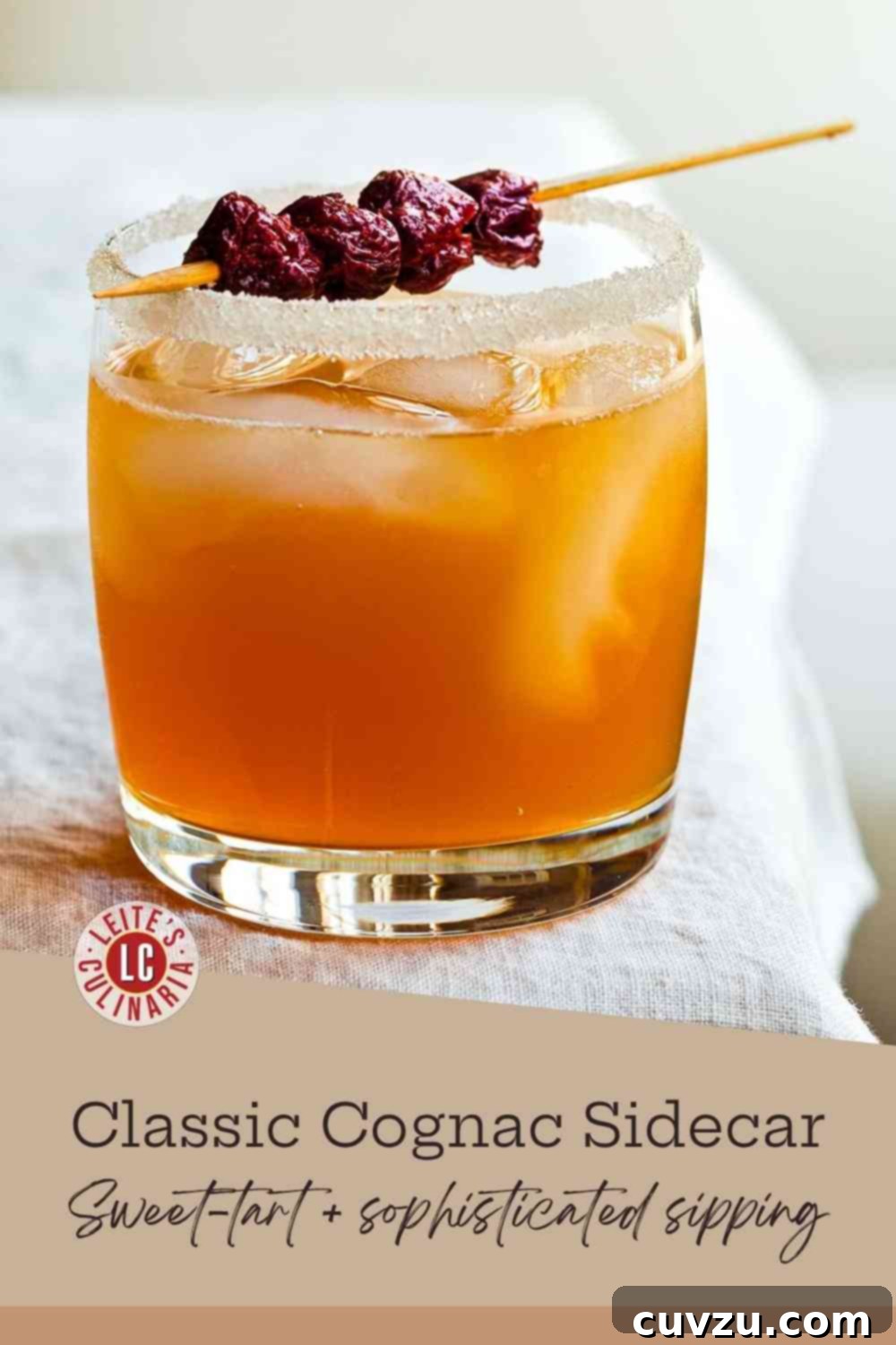Sidecar: The Zest of Classic Cognac 3 A classic Sidecar cocktail in a tall highball glass with a sparkling sugared rim and a skewer of marinated cherries.
