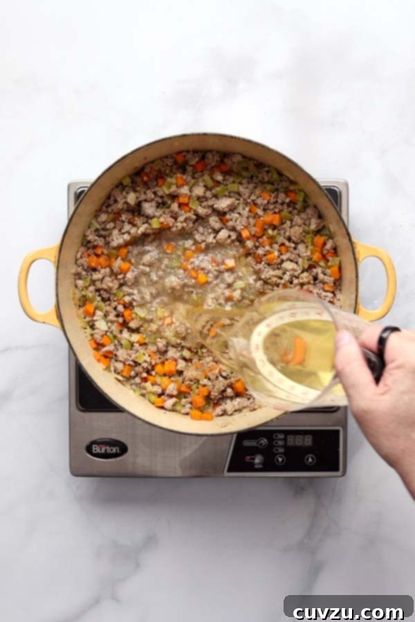Marcella Hazan's Classic Bolognese 11 White wine and freshly grated nutmeg stirred into the Bolognese sauce after the milk has evaporated.