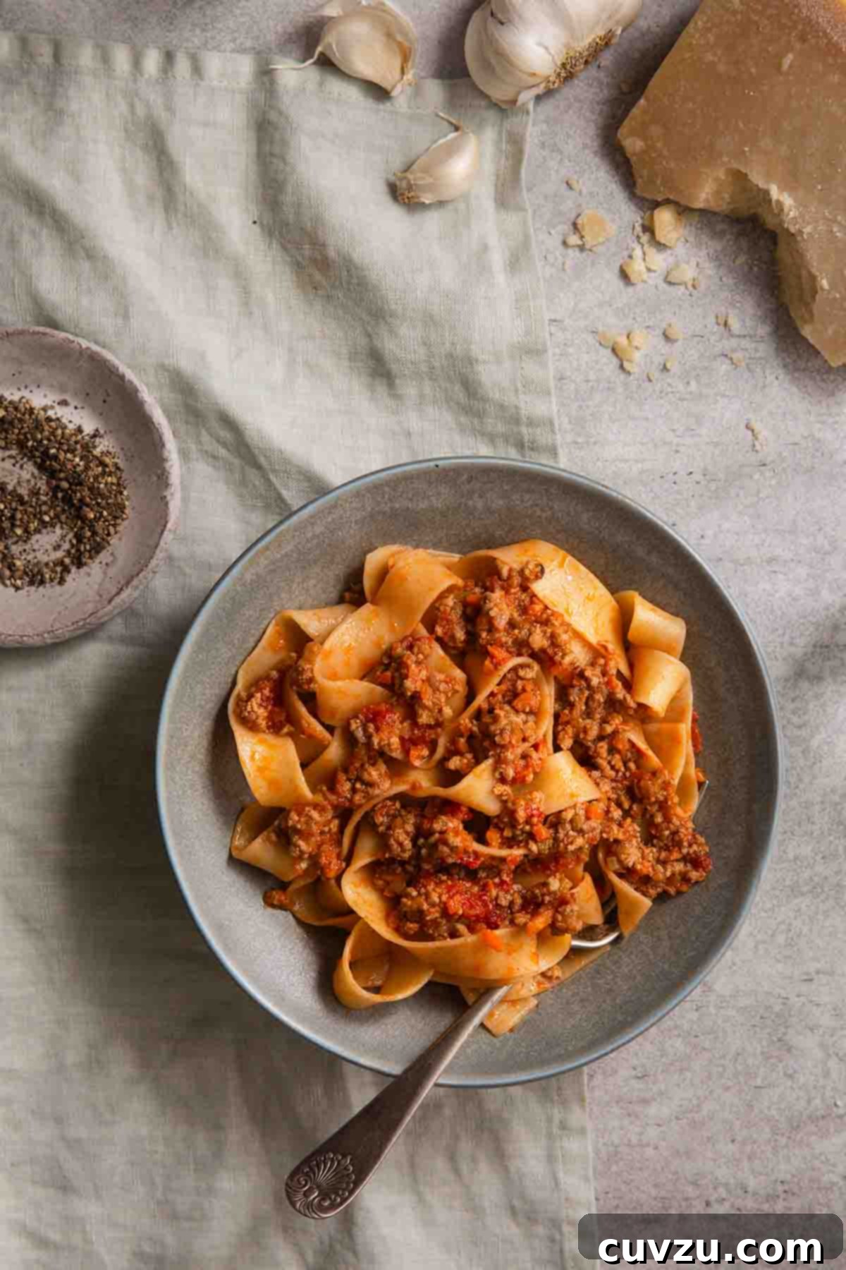 Marcella Hazan's Classic Bolognese 14 The rich, simmering Marcella Hazan Bolognese sauce with visible meat and vegetables in a Dutch oven.