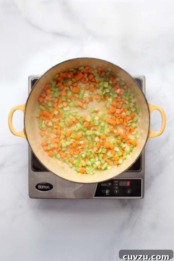 Marcella Hazan's Classic Bolognese 8 Chopped celery and carrots added to sautéed onions in a Dutch oven, forming the soffritto base.