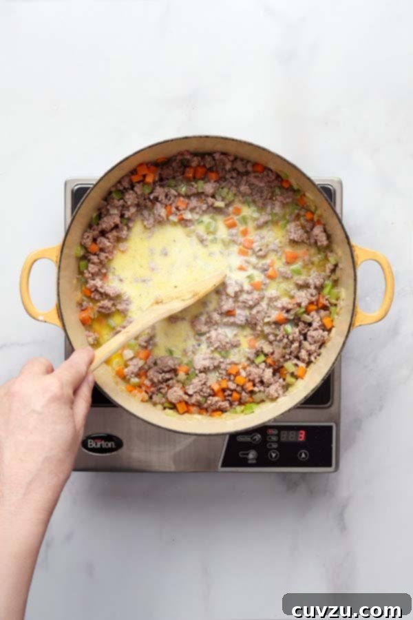 Marcella Hazan's Classic Bolognese 10 Whole milk added to the browned meat mixture, simmering gently until evaporated.
