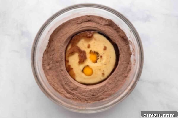 Oil, eggs, and milk in a well in the center of a bowl of dry ingredients.