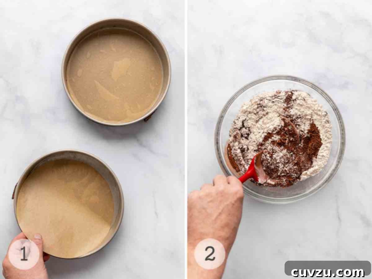 Next-Level Hershey's Chocolate Cake 5 Two 9-inch cake pans, perfectly lined with parchment paper rounds and lightly floured, ready for batter. In the background, a person is diligently mixing dry ingredients in a large bowl with a spoon, highlighting the ease of preparation.