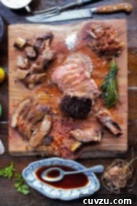 Jamie Oliver's Signature Sunday Feast 3 A medium-rare rib roast deboned and sliced into pieces on top of a wooden cutting board, ready to serve.