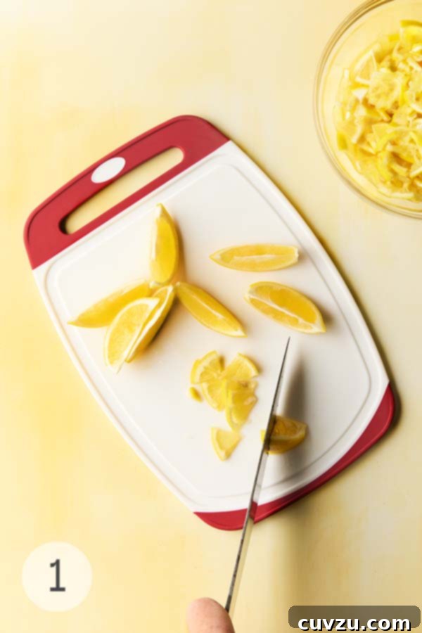 Fragrant Meyer Lemon Marmalade 7 A person cutting Meyer lemons in quarters.