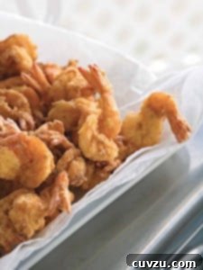 Pieces of bayou fried shrimp in a paper towel-lined bowl.