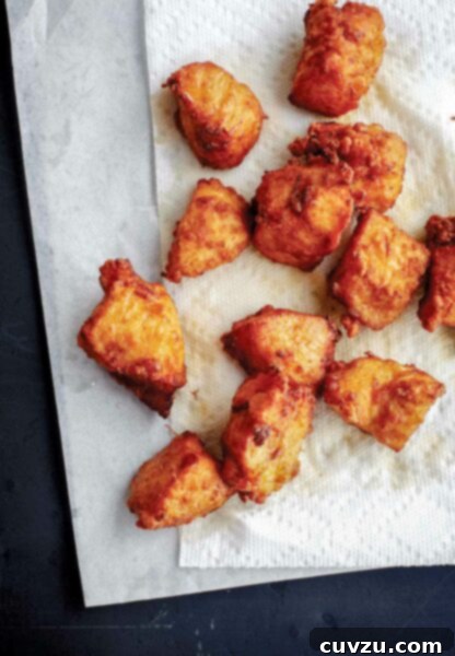 A dozen pieces of double fried Japanese chicken on a paper towel, ready to be served.