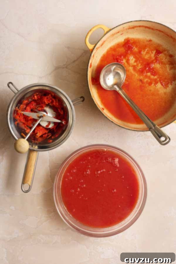 The Art of Homemade Tomato Paste 7 Passing cooked tomatoes through a food mill to create a smooth purée and remove skins and seeds.