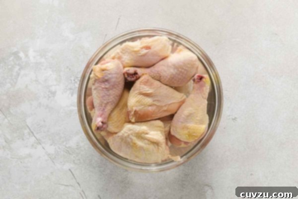 Effortless Extra Crispy Batter Fried Chicken 19 Chicken pieces submerged in brine.
