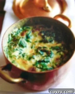 Velvety Creamed Spinach 5 A copper pot filled with creamed spinach.