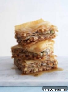 Three pieces of vegan baklava stacked on top of each other.