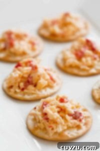 Crackers topped with pimento cheese.
