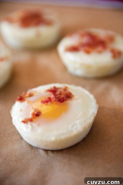 Oven-Baked Delights 3 Four baked eggs sprinkled with chopped bacon.