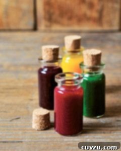 Four bottles of natural food coloring in different shades.