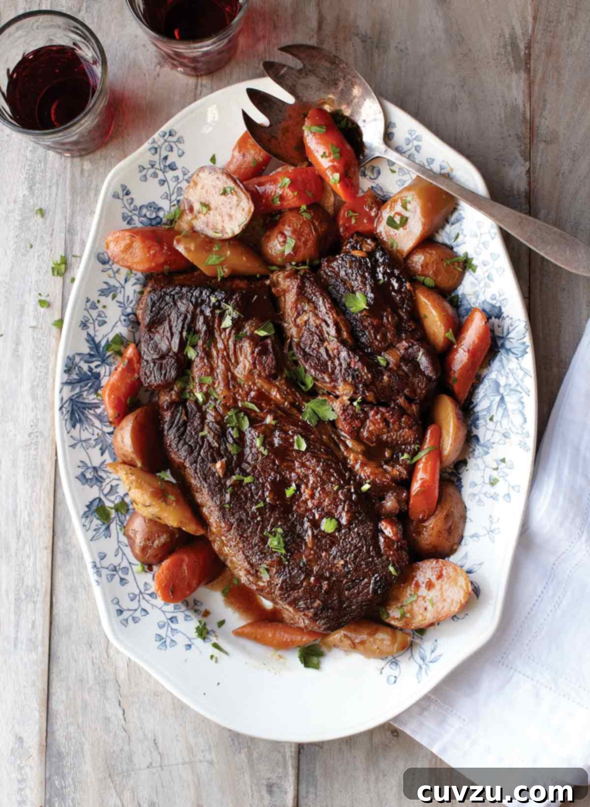Tender Pot Roast and Veggie Comfort 2 A beautifully presented pot roast with potatoes and vegetables on a decorative platter, ready to be served.