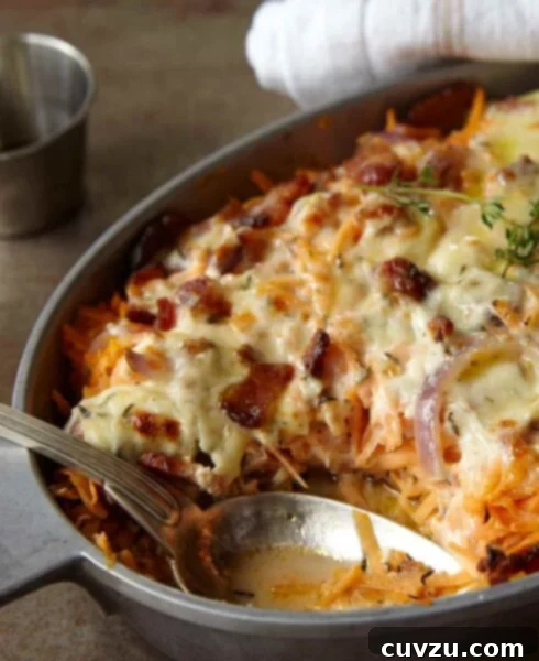 Sweet and Savory Chicken, Sweet Potato, and Bacon Casserole 4 A golden, bubbling chicken, sweet potato, and bacon casserole in an oval dish, with melted cheese on top.