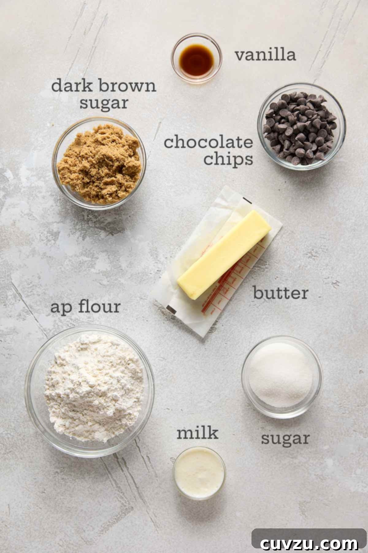 Decadent Egg-Free Chocolate Chip Cookie Dough 5 A beautiful flat lay of ingredients for eggless chocolate chip cookie dough including sugar, vanilla extract, chocolate chips, butter, milk, and flour, all perfectly arranged.