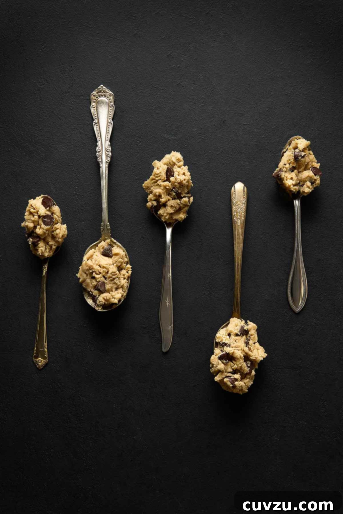 Decadent Egg-Free Chocolate Chip Cookie Dough 9 Five silver spoons, each with a perfect scoop of eggless chocolate chip cookie dough, inviting you to taste.