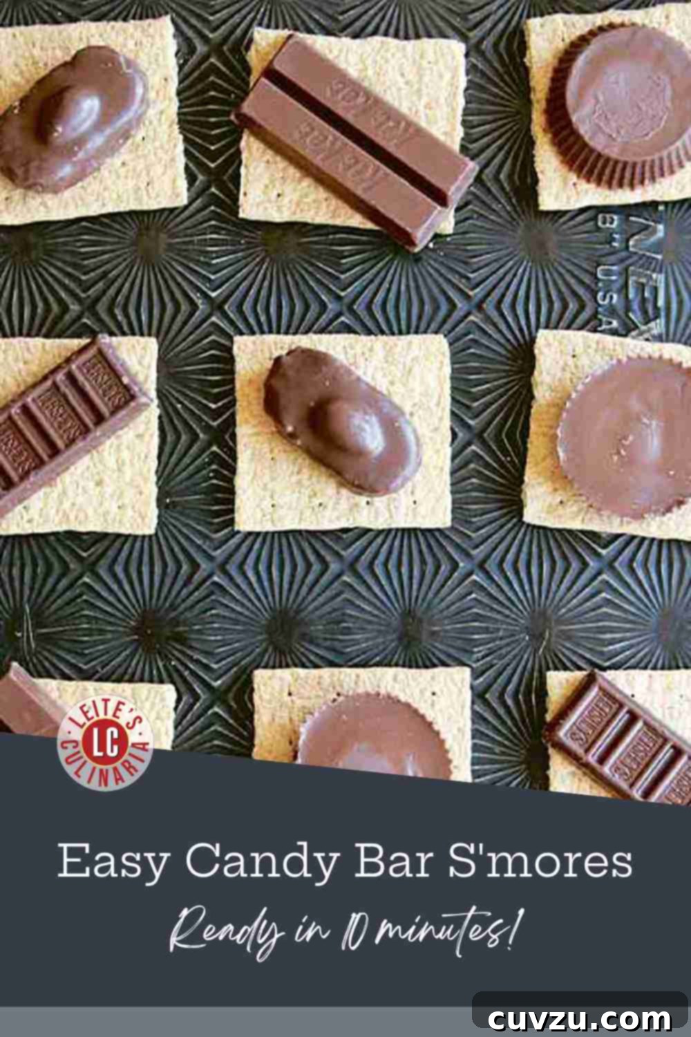 Decadent Candy Bar S'mores 3 A close-up shot of graham cracker squares arranged on a baking sheet, each topped with various pieces of chocolate candy, awaiting marshmallows and broiling.