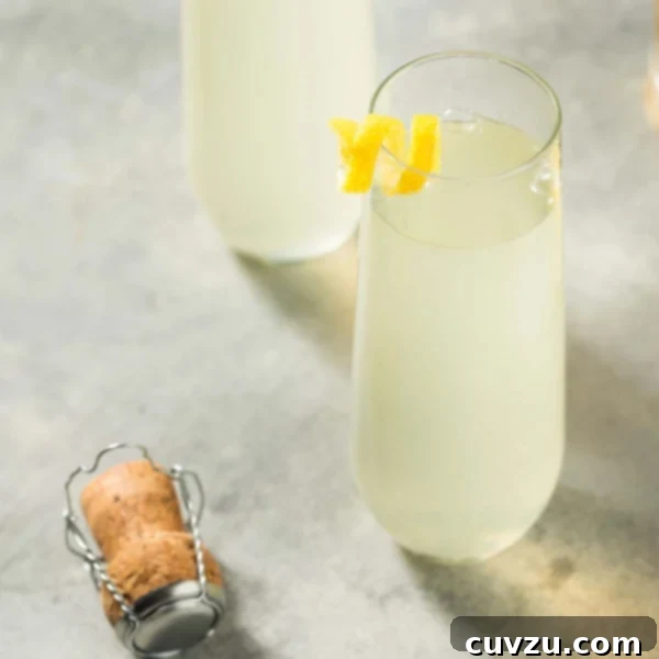 French 75 for a Party 6 lose-up of a bubbly French 75 cocktail topped with a fresh lemon twist.